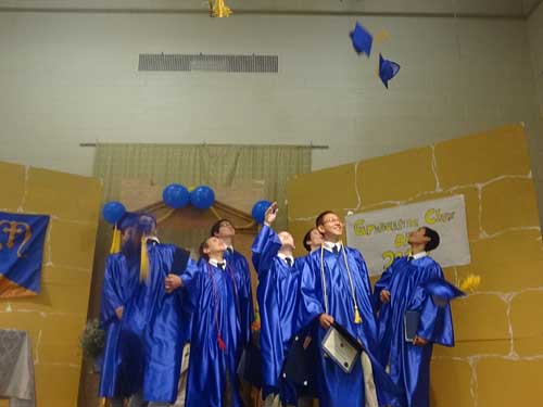 grade eight graduates toss up their caps